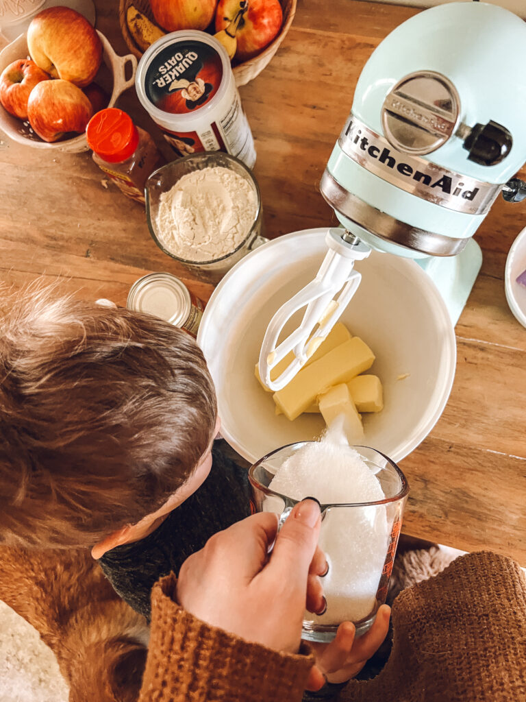 Child helping pour ingredients in mixer