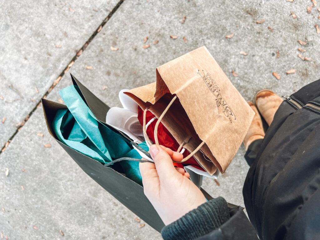 Hand holding multiple shopping bags